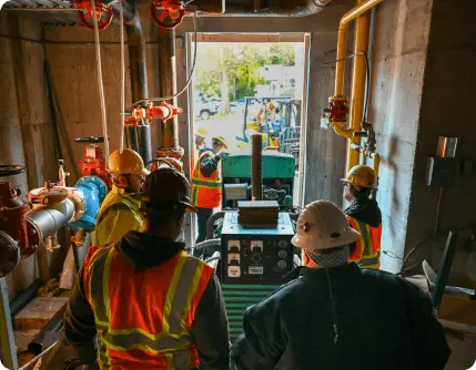 Commercial Electrical Workers looking over an electrical configuration