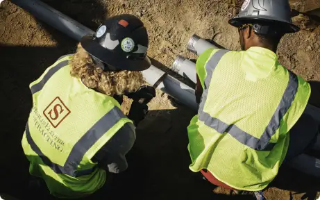 Two electric workers testing their setup Commercial electrical contracting